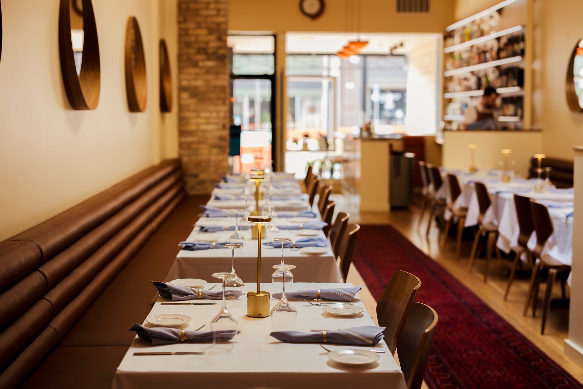 The Kismet dining room with its leather banquette and round walnut mirrors
