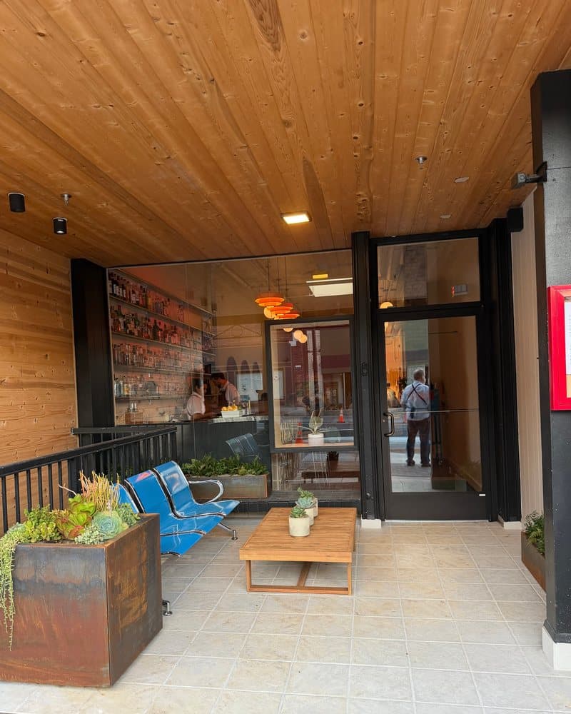 The covered patio out front, with the blue airport bench